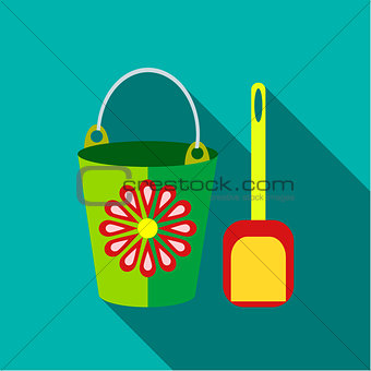 Children's toy pail with shovel in blue-green background