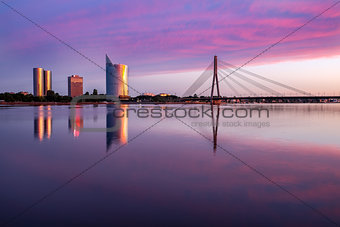 Riga view on cable-braced bridge over Daugava river and new buildings at other bank of it.