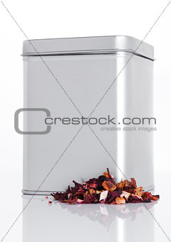 Fruit tea steel jar with loose tea next to it