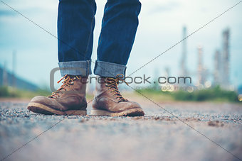 Smart Man Engineer Wear Jeans And Brown Boots for Worker Security on Background of Refinery
