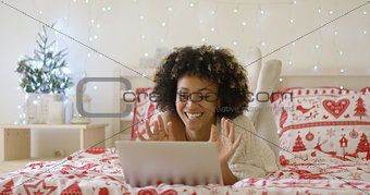 Gorgeous young woman in bed with computer