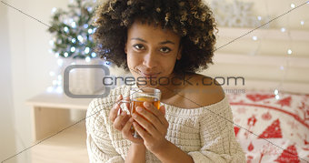 Smiling woman holding hot tea