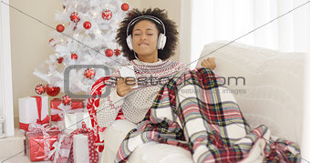 Happy woman listening to music on Christmas Day