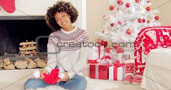 Smiling young woman holding a Santa hat
