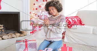 Pretty young woman checking her Christmas gifts