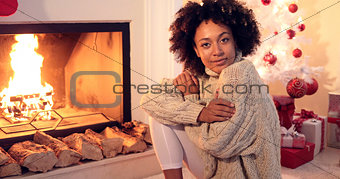 Woman smiles at camera while wearing sweater