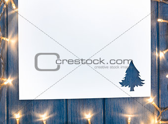 cut paper with lights in fir-tree shape on table