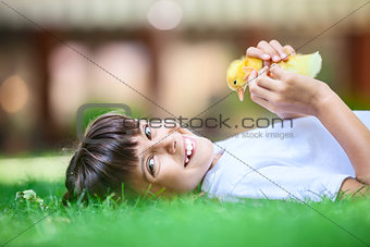Little girl with a spring duckling