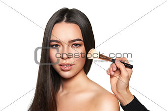 Closeup portrait of beautiful woman with brush