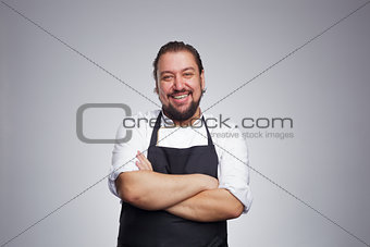 Pleased chef looking confidently at the camera and laughing. Pro