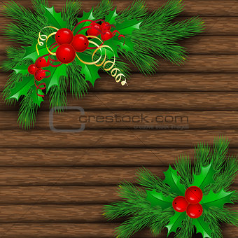 Christmas tree, holly and decorative elements on background of boards