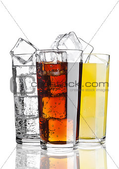 Glasses of cola orange soda lemonade with ice