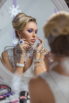 Beautiful bride looking in mirror