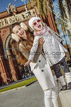 cheerful modern mother and daughter in Barcelona, Spain