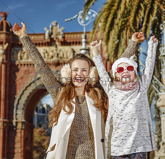 mother and child near Arc de Triomf in Barcelona rejoicing