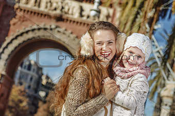 mother and child near Arc de Triomf in Barcelona hugging