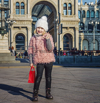 happy girl at Piazza del Duomo in Milan, Italy handwaving