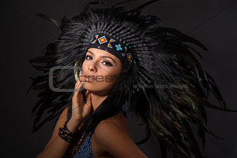Portrait of young woman in costume of  American Indian