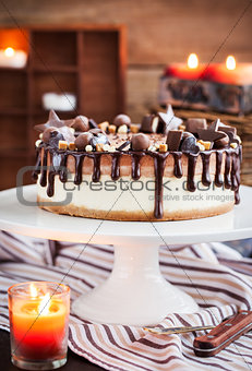 Two-ply chocolate cheesecake decorated with candies and frosting