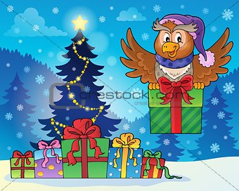 Owl with gift near Christmas tree