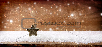Christmas wooden background with star and snowfall.