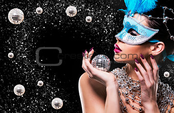 disco woman wearing silver accessories on black backgound