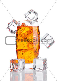 Glass of orange energy soda drink with ice cubes