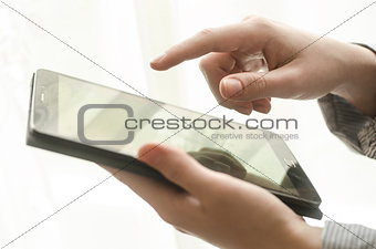 Women's hands holding a tablet