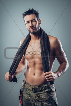 Cool athletic man posing with towel