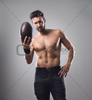 Shirtless football player with ball