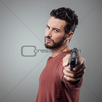 Cool young man holding a gun