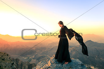 Woman with a scarf in the mountains