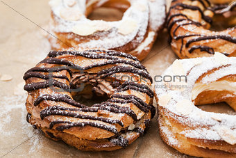 Chocolate and powdered sugar cream puff rings (choux pastry)