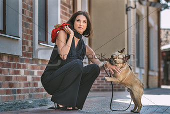 Beautiful woman with dog on the street