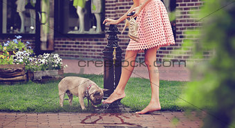 Girl with dog washing legs in the well