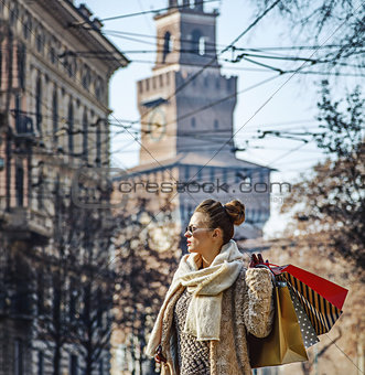 trendy traveller woman in Milan, Italy looking into distance