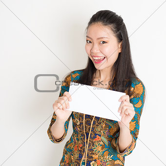 Southeast Asian female hand holding white paper card