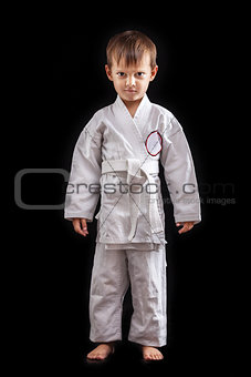 Young boy in kimono against black background
