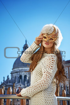 elegant fashion-monger in Venice, Italy wearing Venetian mask