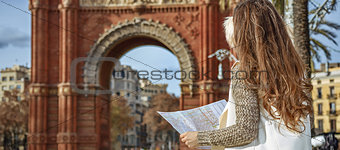woman near Arc de Triomf in Barcelona, Spain looking at map