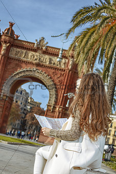 woman near Arc de Triomf in Barcelona, Spain looking at map
