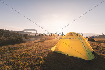 Camping on hill with warm sunlight