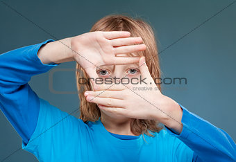 Boy Looking Through a Finger Frame