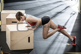Sportive girl does exercise in gym