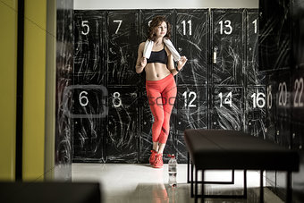 Athletic woman posing in locker-room
