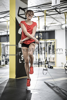 Sportive girl does exercise in gym