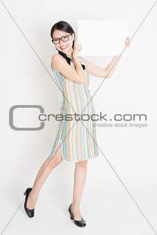 Oriental girl holding white blank paper card