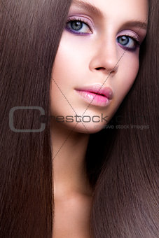 Beauty Woman with Very Long Healthy and Shiny Smooth Brown Hair.