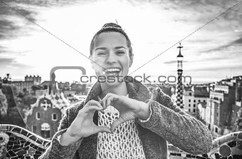 smiling woman at Guell Park showing heart shaped hands
