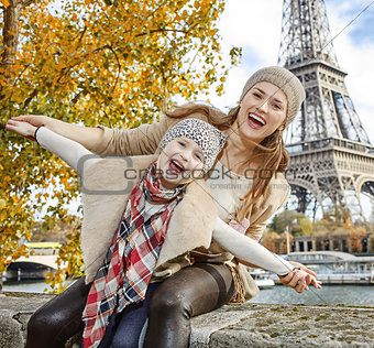 smiling mother and daughter travellers having fun time in Paris